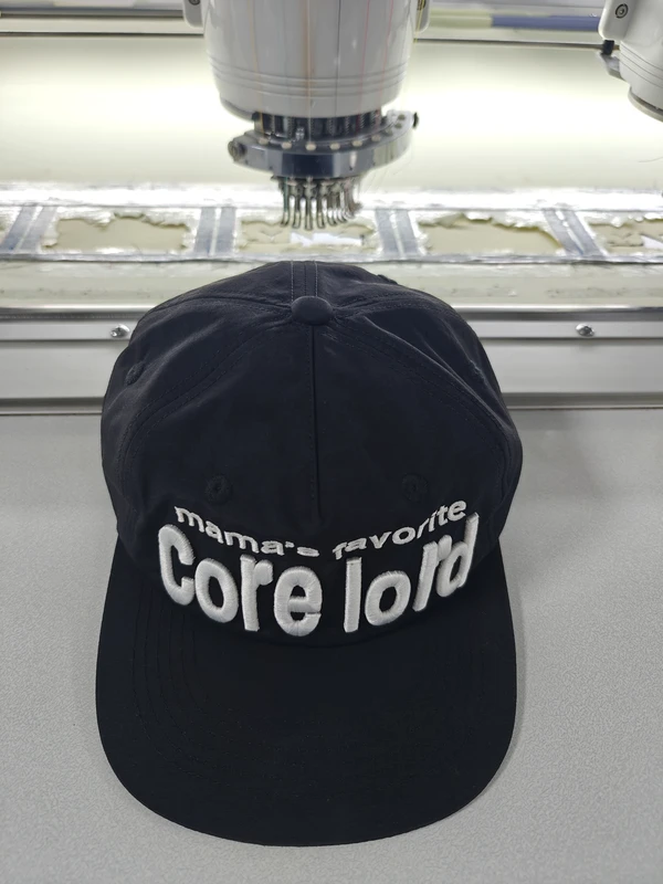 Black custom baseball cap with prominent white raised embroidered lettering