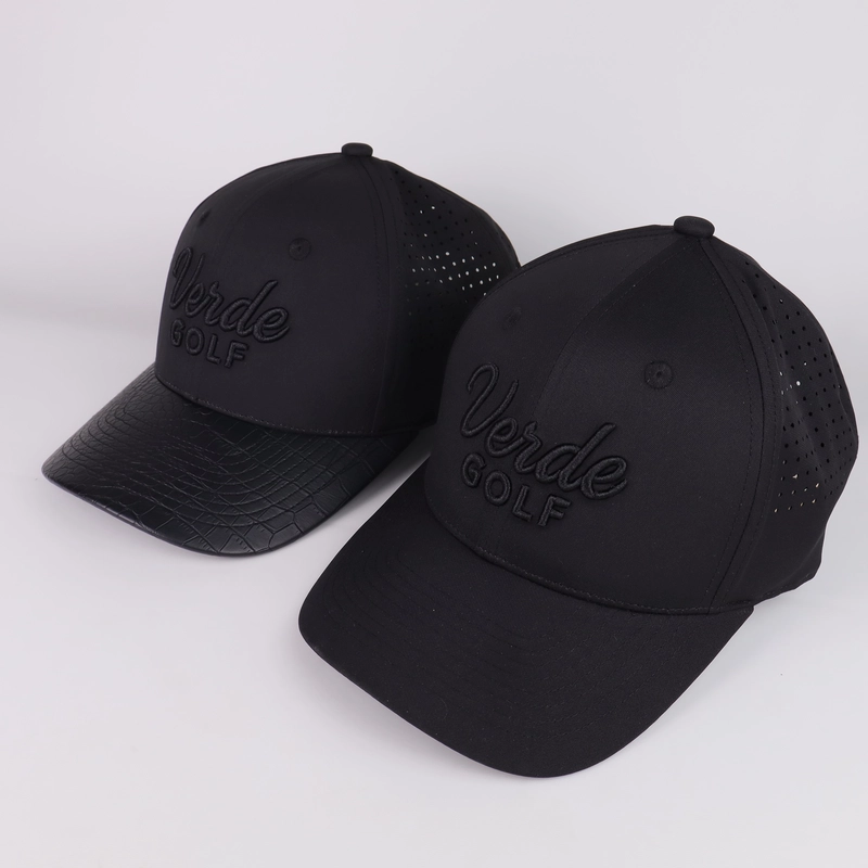Two black golf cap samples with tonal logos, curved visors and ventilated perforated side panels