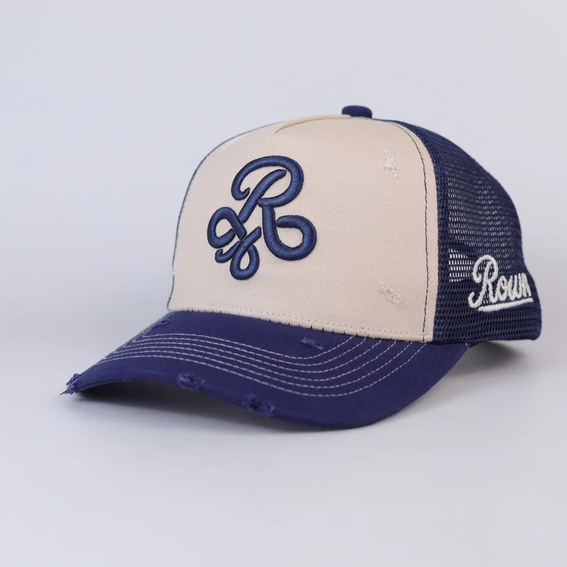 Three-quarter navy cream distressed trucker showing side branding