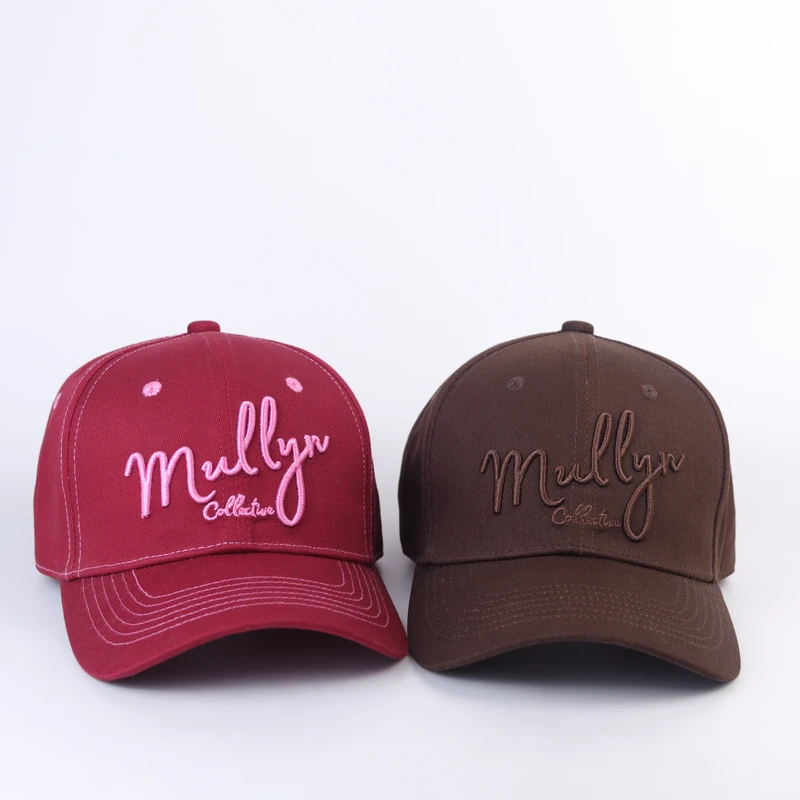 Burgundy and brown curved-brim caps shown together with contrasting script embroidery