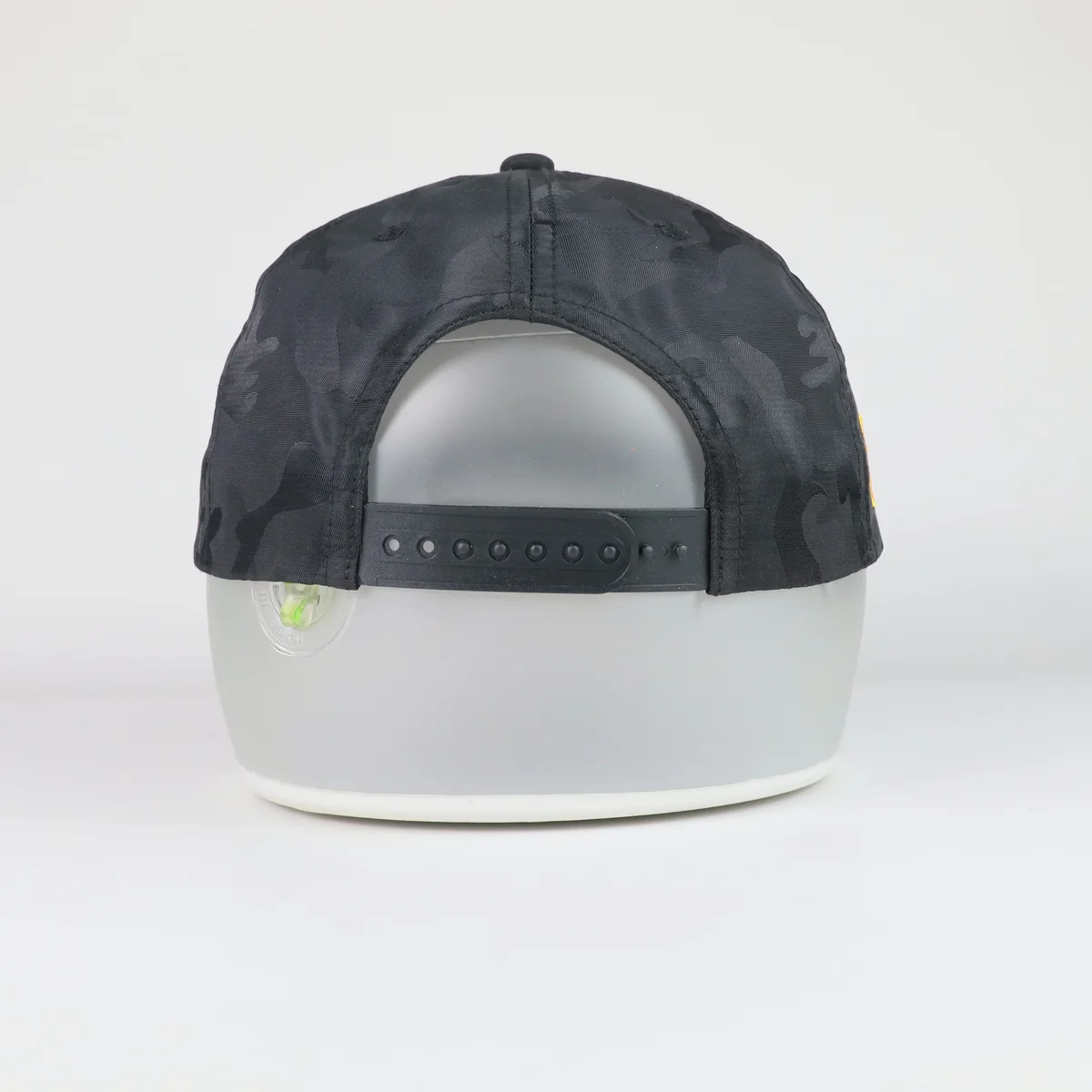 Alternate angle of black camouflage baseball cap with front yellow lettering