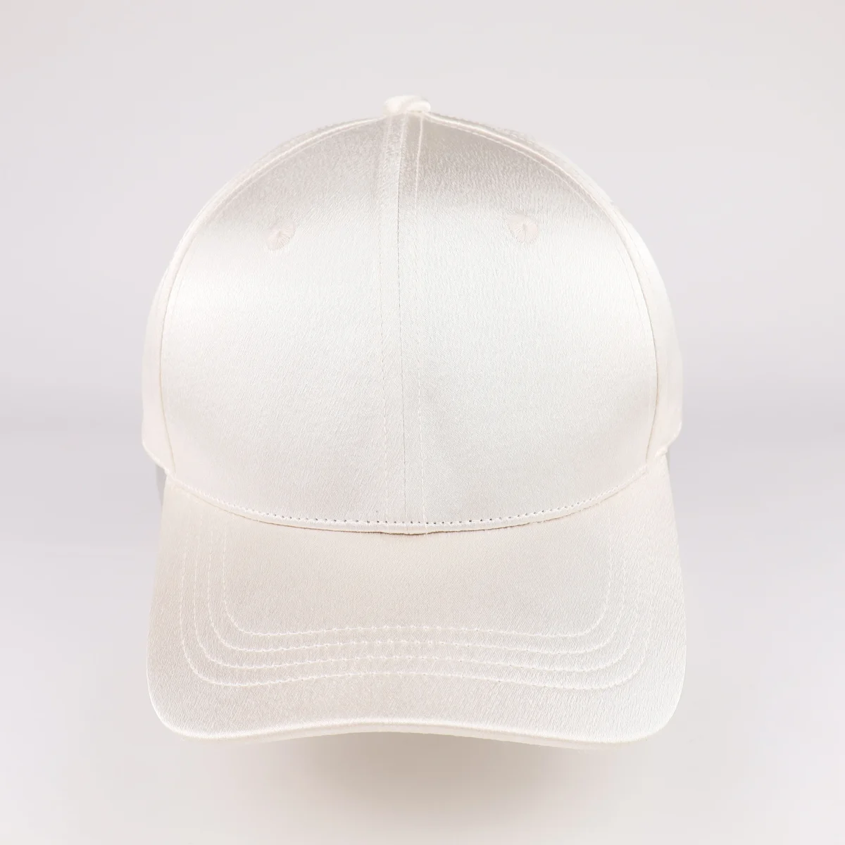 Front view of unbranded ivory smooth-finish cap with curved brim