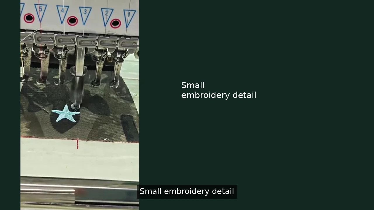 Embroidery needle stitching a light blue star onto a flat fabric piece in the Caps Mill workshop